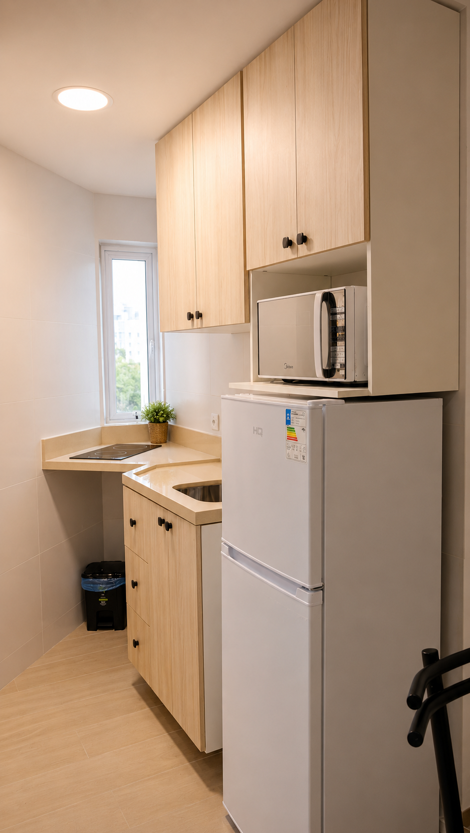 Cozinha equipada do apartamento no Bahia Flat, na Barra, Salvador, com geladeira, micro-ondas, cooktop, pia e armários planejados.